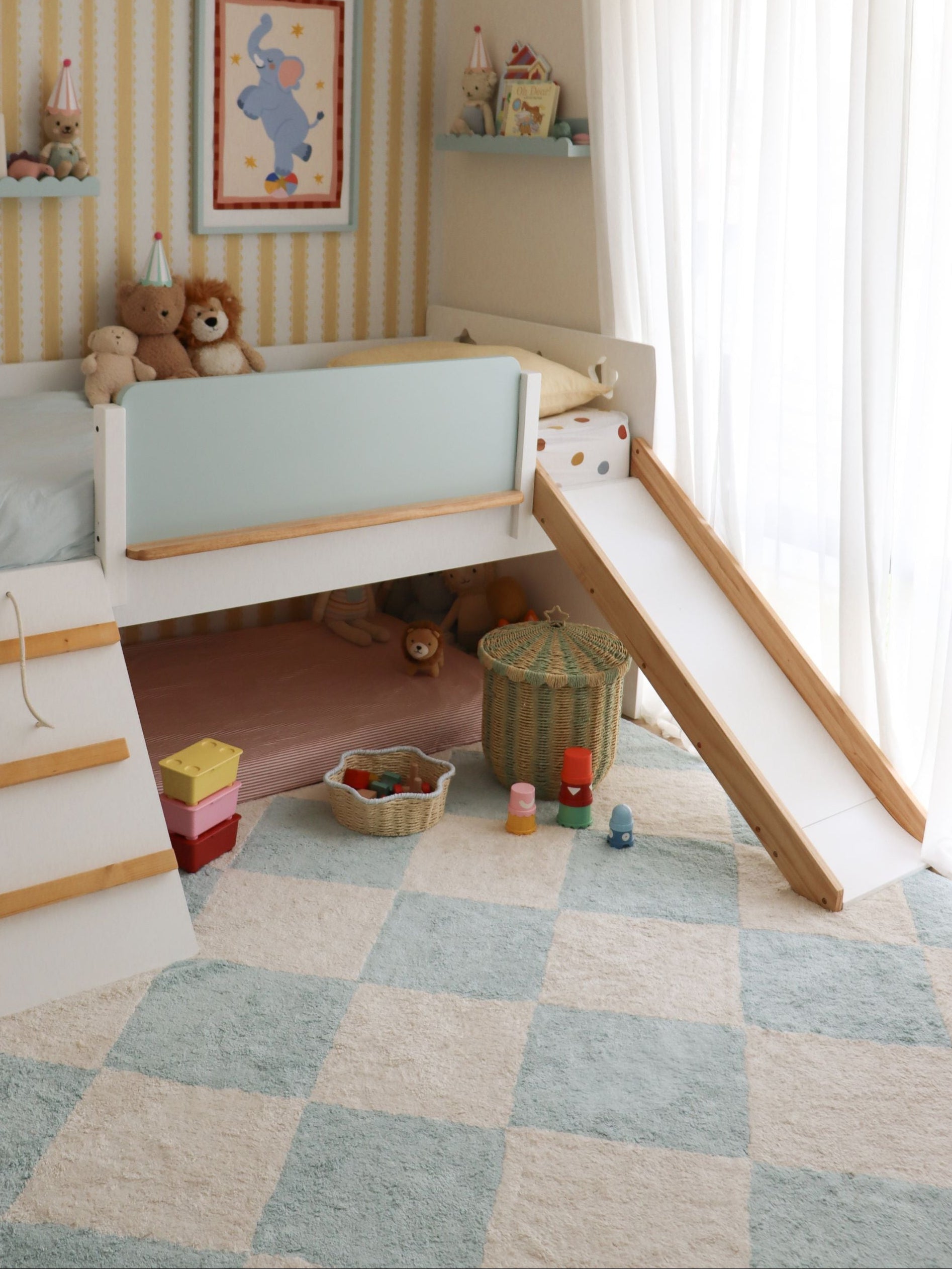 Children's room with a slide, toys, and colorful walls.