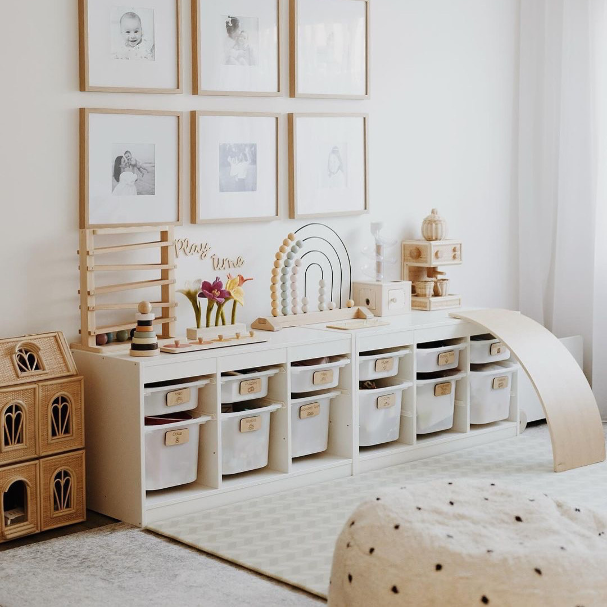 Children's playroom with wooden furniture, storage units, and decorative elements.