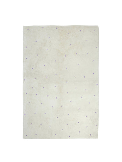 Natural rug with lavender purple dot details
