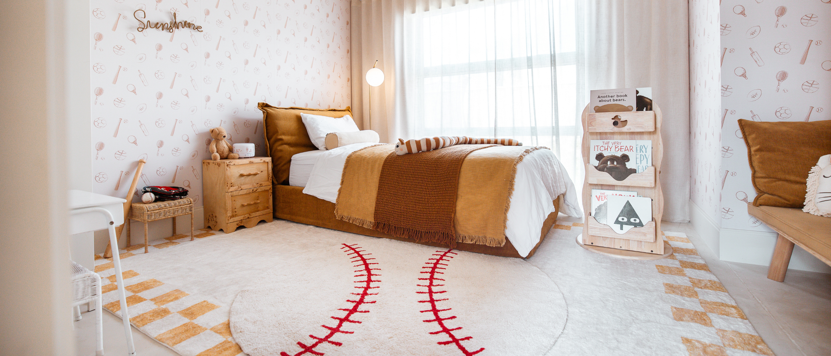 Children's bedroom with a bed, desk, and decorative items.